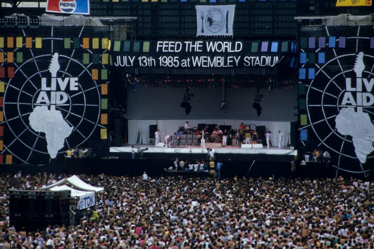 LONDON, UNITED KINGDOM - JULY 13:  A general view of the crowd and the stage during the Live Aid concert at Wembley Stadium in London, 13th July 1985. The concert raised funds for famine relief in Ethiopia.  (Photo by Georges De Keerle/Getty Images)